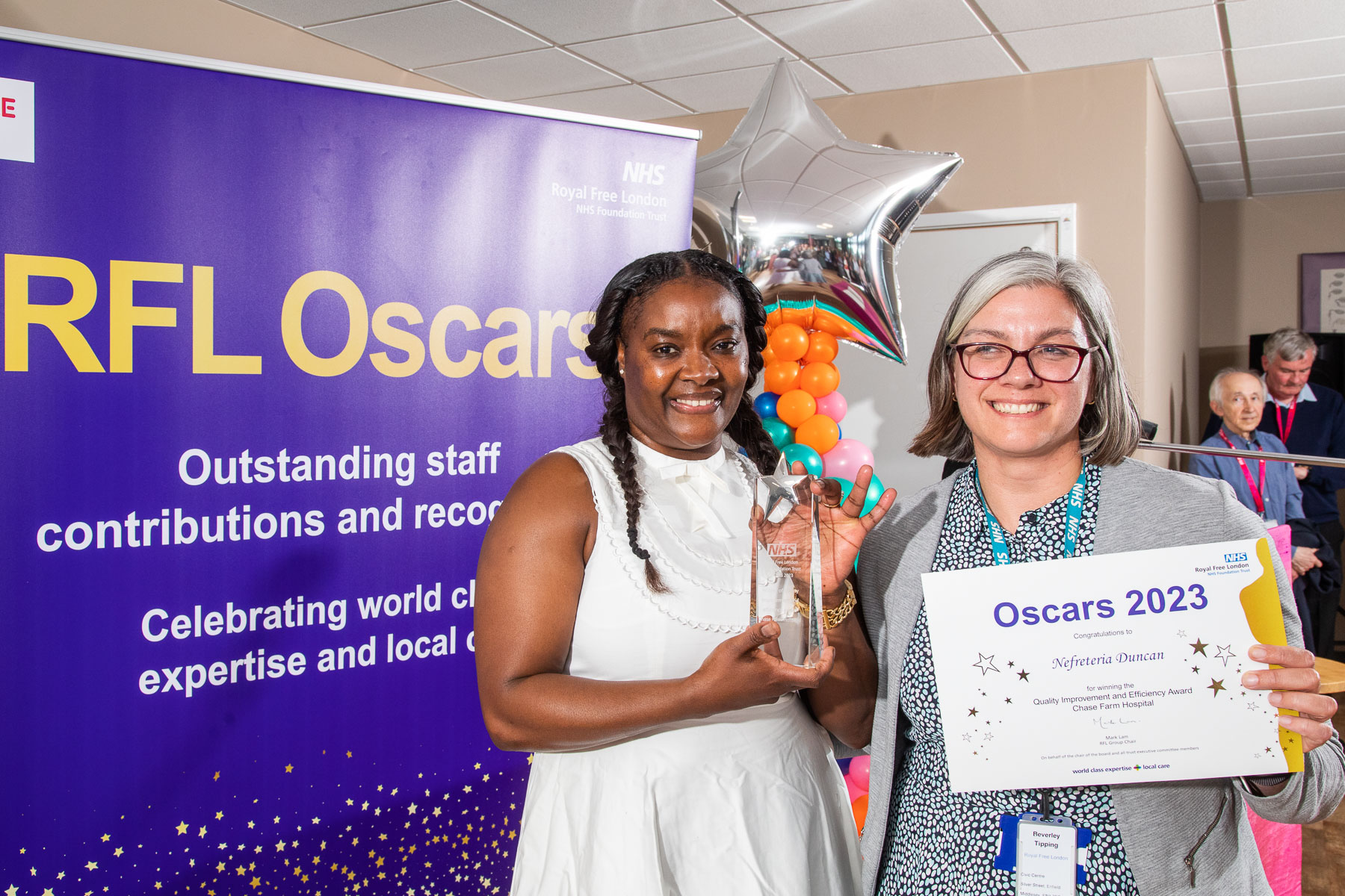 Nefreteria Duncan posing with her award and certificate alongside Bev Tipping