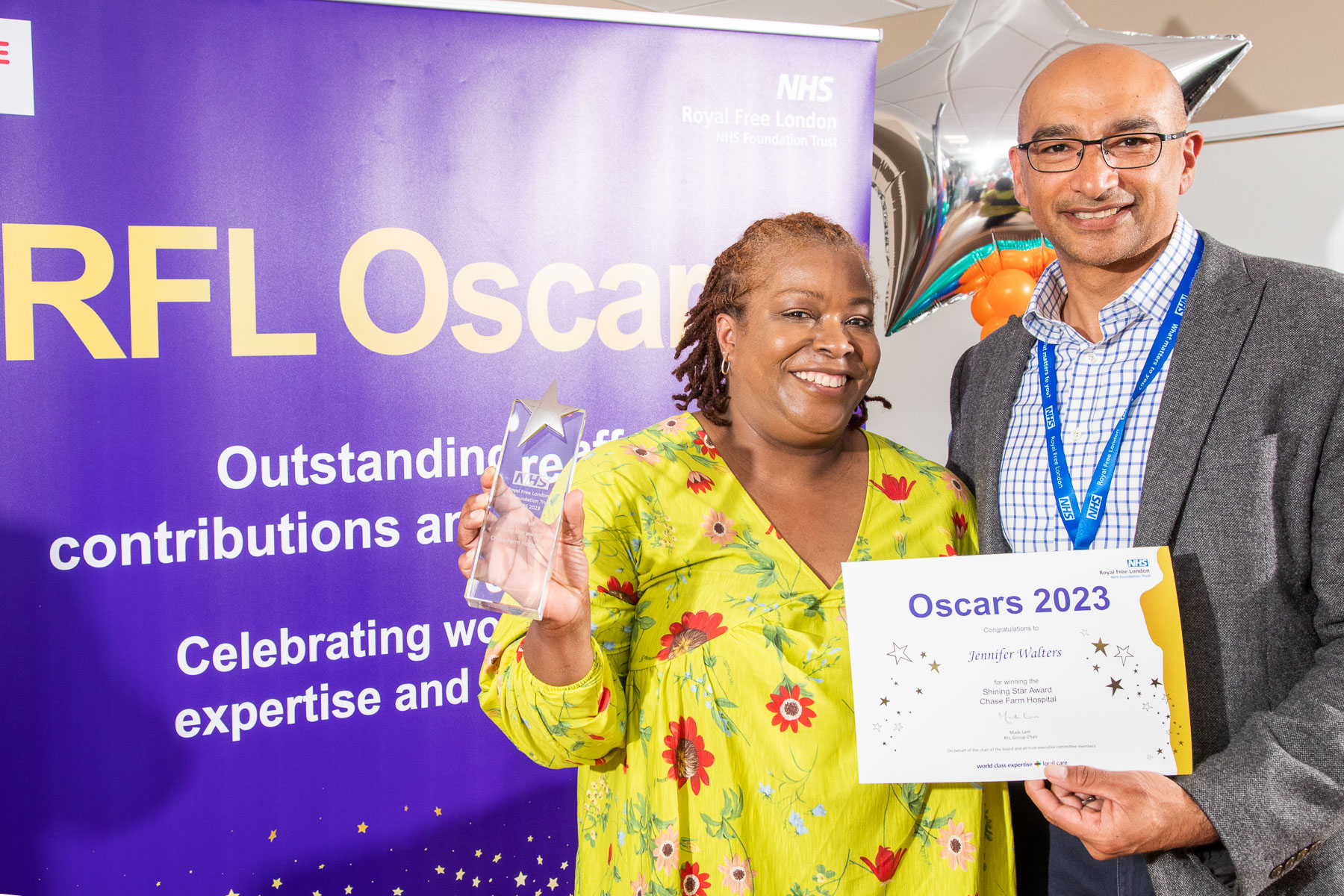 Jennifer posing with her award and certificate alongside Ash Saini