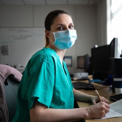 Medical staff in scrubs with a surgical mask